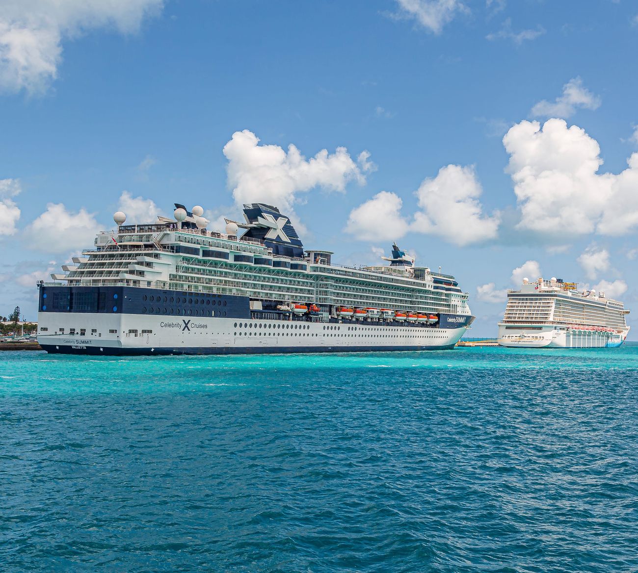 Cruise ships docked in turquoise harbour water, a short walk from the Fish Fry at Arawak Cay