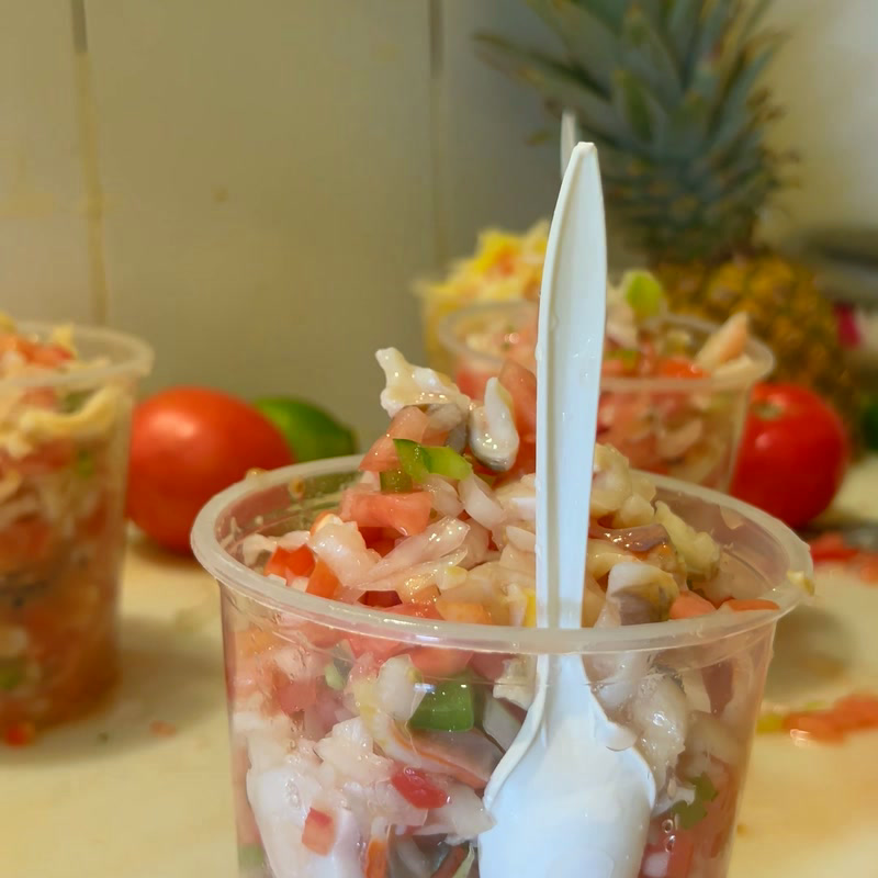 Cups of fresh conch salad lined up on the counter